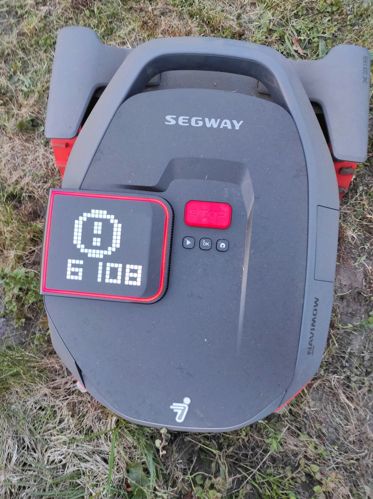 Draufsicht auf einen schwarzen Mähroboter der Marke Segway mit einem rot umrandeten Display auf dem der Fehlercode 6108 zu erkennen ist.